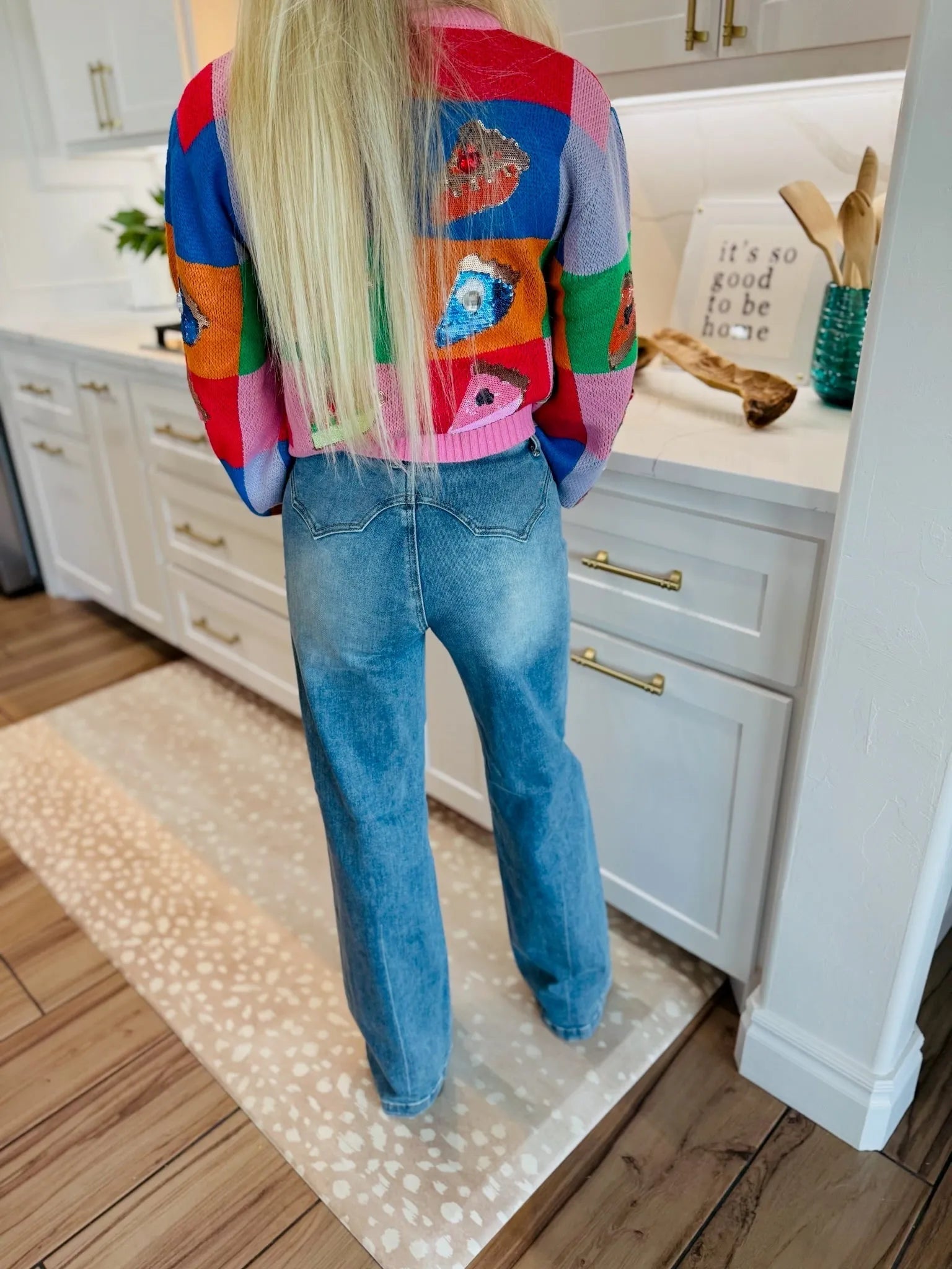 Back view of woman wearing SAIGE High-Rise Double-Pocket Wide-Leg Jeans in blue denim, featuring a Western-style yoke.