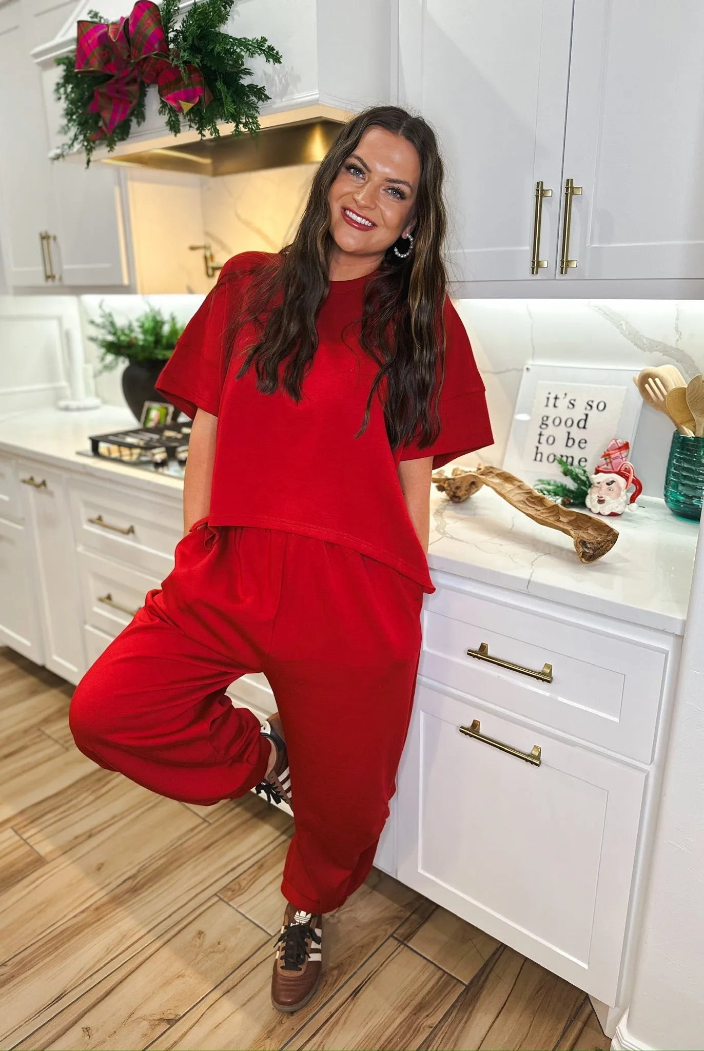 Woman wearing a solid red round neck short-sleeve top and matching semi-harem pants. The outfit is casual and comfortable.