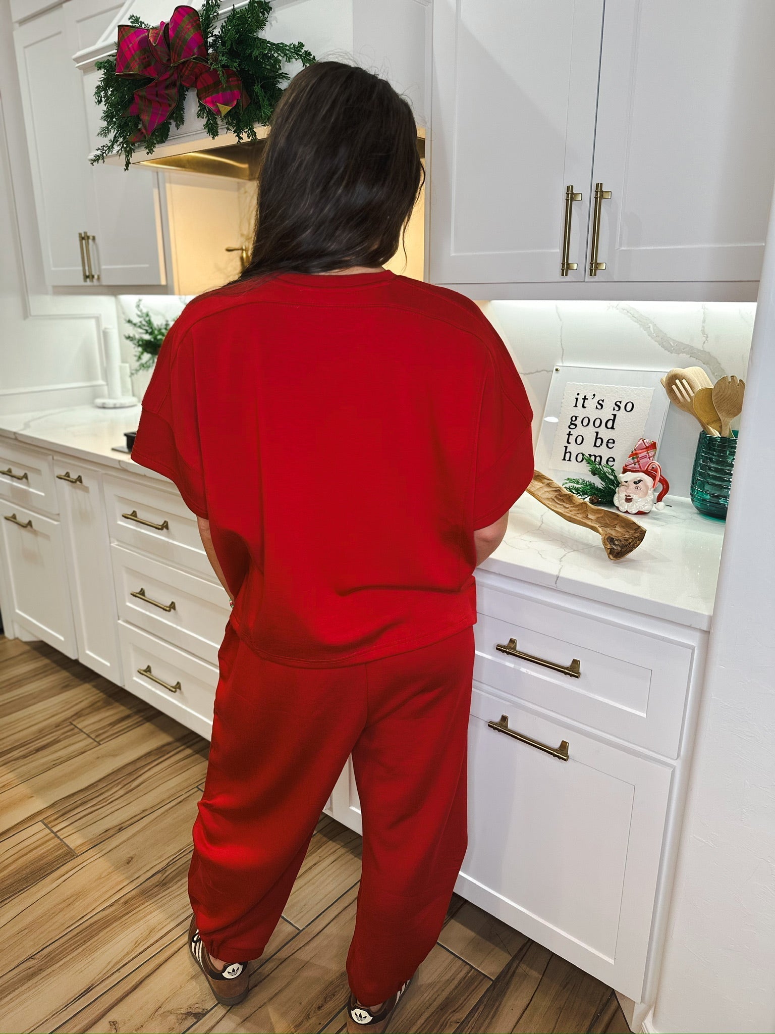 Woman in solid red round neck short-sleeve top and matching semi harem pants. Casual loungewear set.