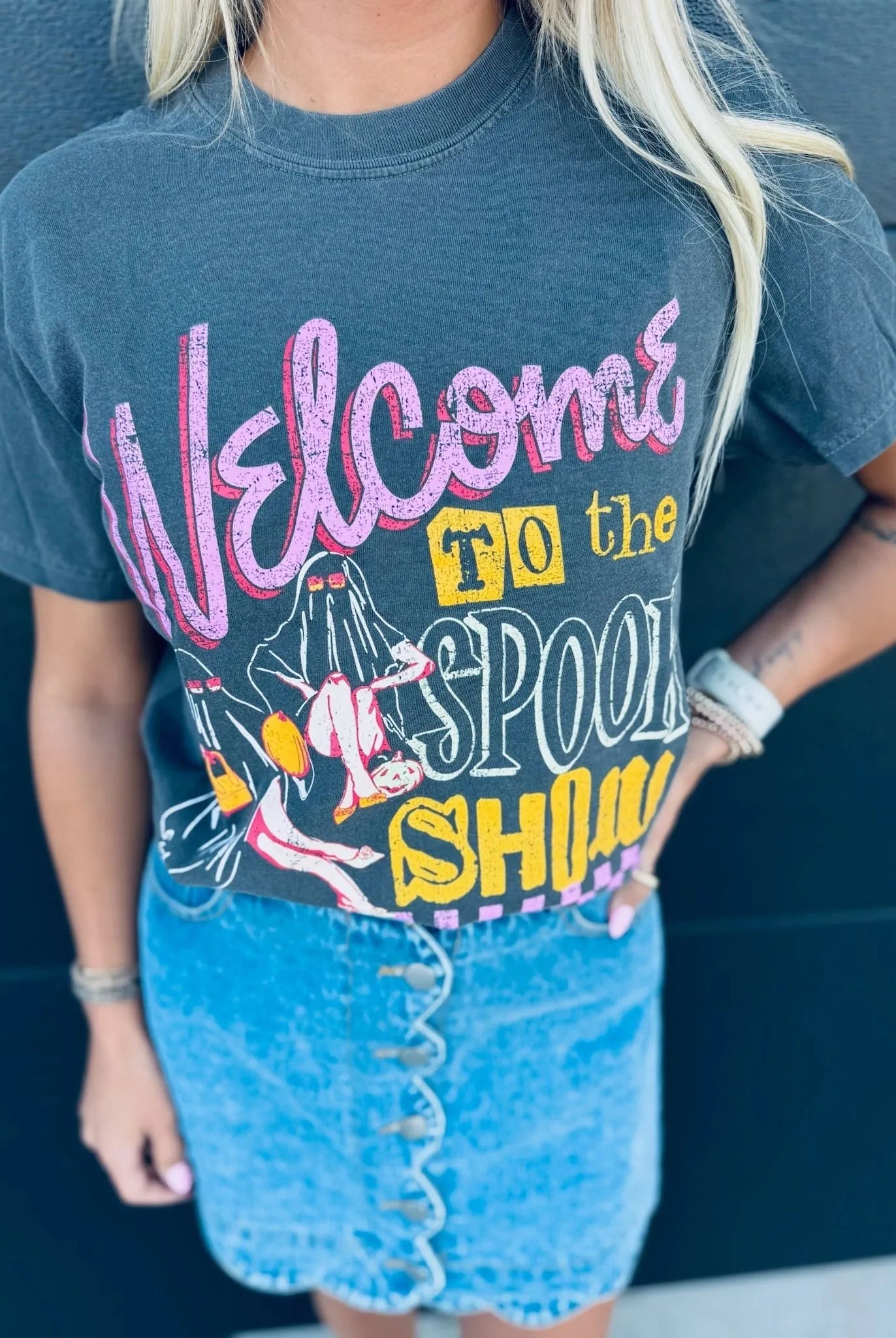 Dark grey "Spook Show Halloween" graphic t-shirt featuring pink and yellow text with ghost illustrations.
