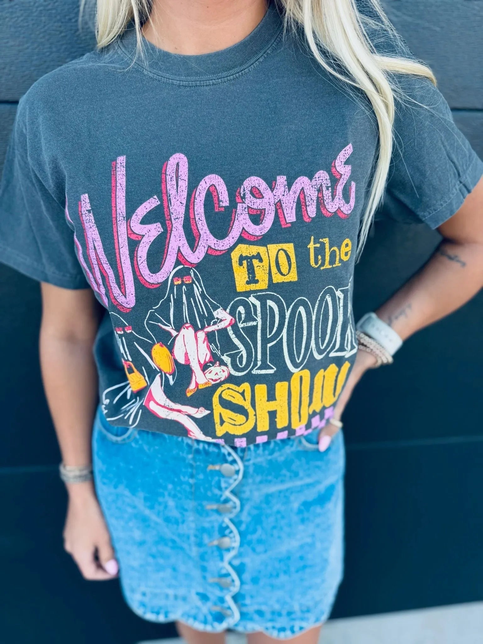 Dark grey "Spook Show Halloween" graphic t-shirt featuring pink and yellow text with ghost illustrations.