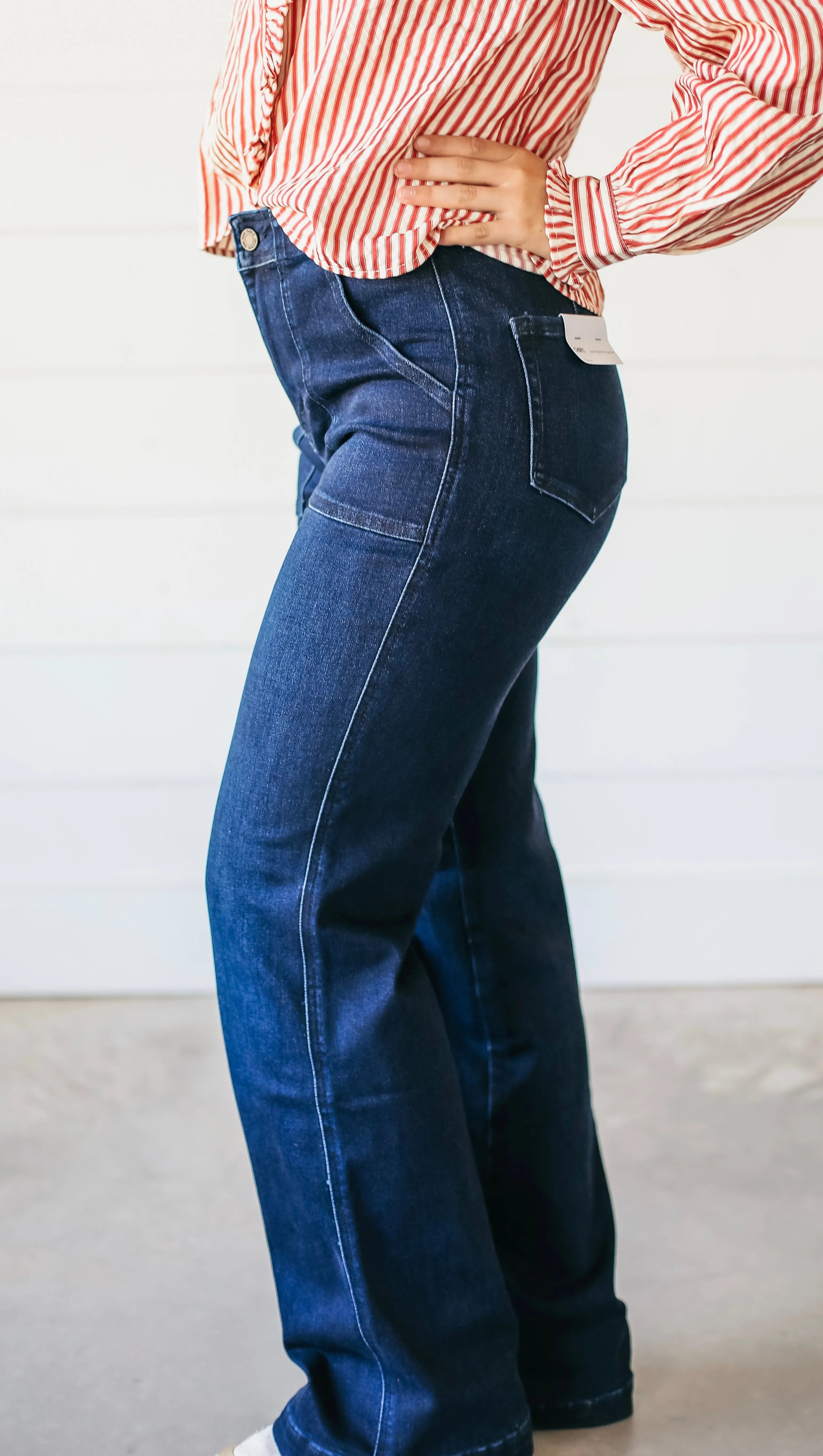 Dark wash denim flare jeans with contrast stitching and a high-rise waist.