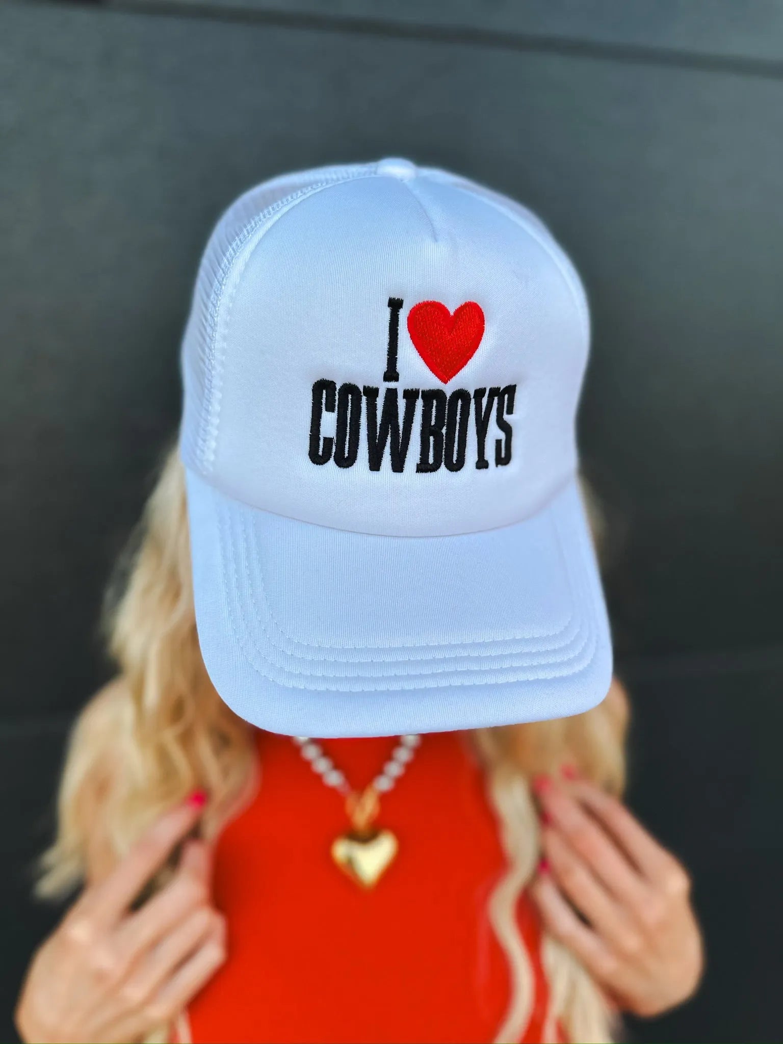 White trucker hat with embroidered black text 'I' and a red heart, followed by 'COWBOYS'.