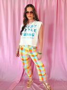 Model wearing Madras Plaid High Waist Barrel Pants in Poppy and Pine, featuring colorful stretch denim in a plaid pattern