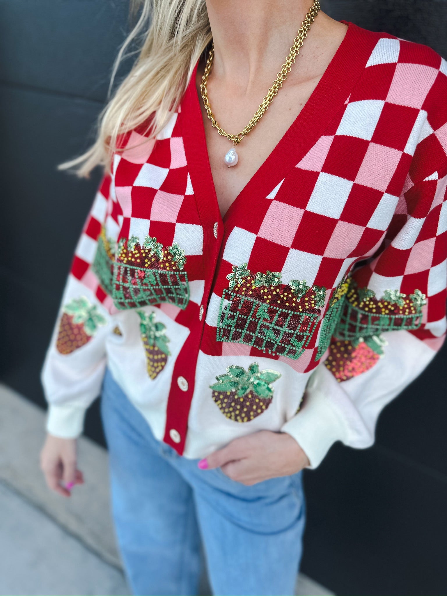 Queen of Sparkles red and white checkered sequin strawberry cardigan with front pockets and strawberry appliques.