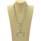 Large silver horse bit necklace with a thick, braided chain, displayed on a mannequin bust.