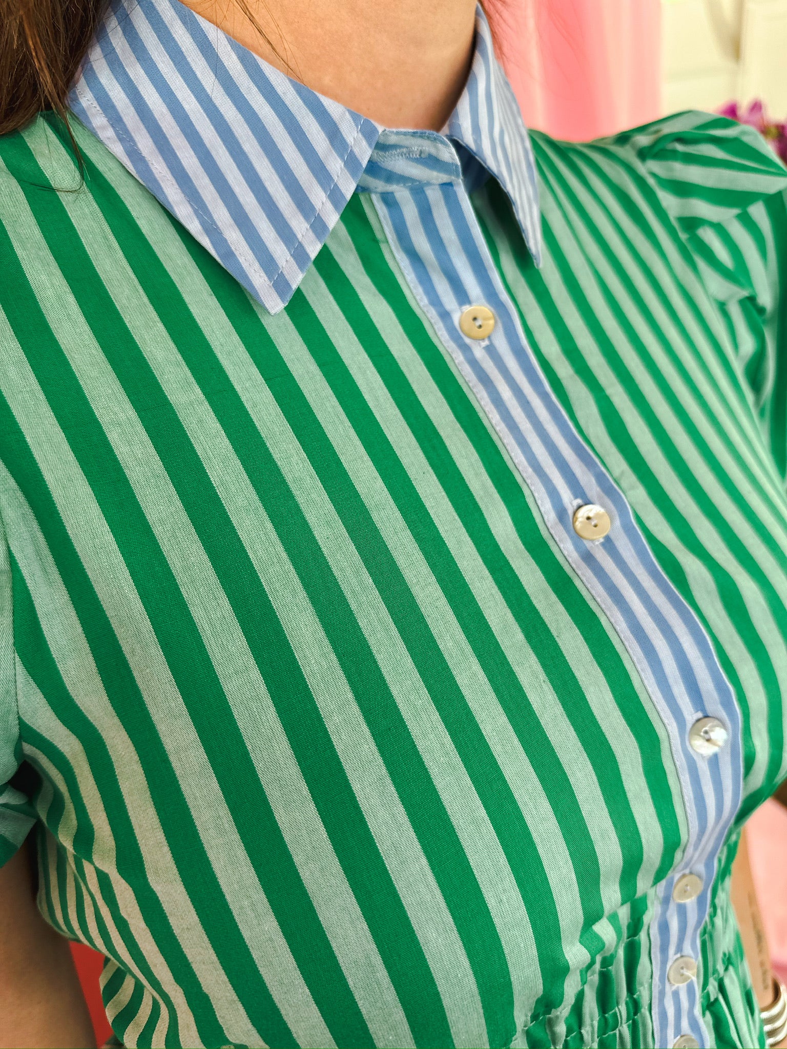 Green and light blue striped dress with puff sleeves and button details