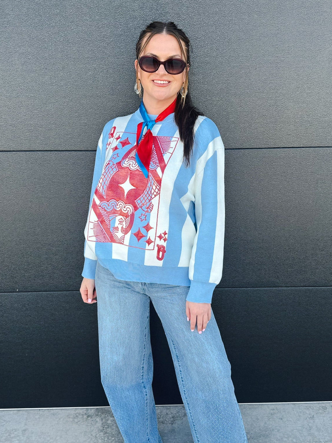 Queen of Sparkles patriotic sweater with blue and white stripes and a large queen of hearts card graphic on the front.