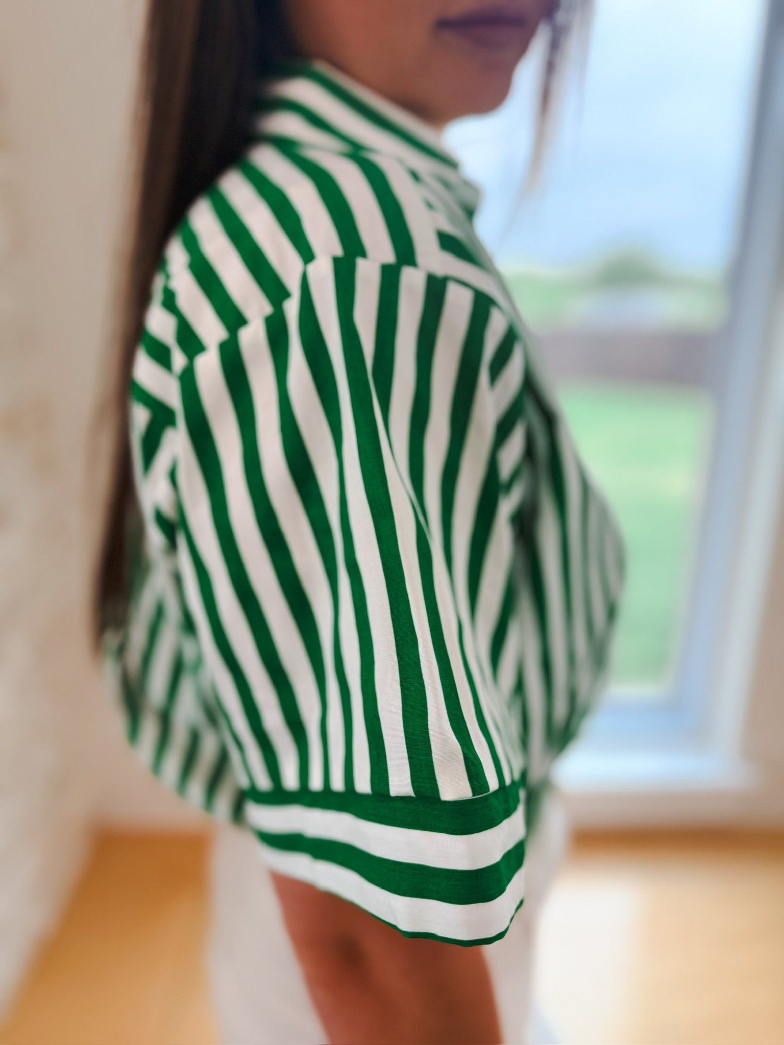 Kelly green and white striped V-neck lapel collar crop top, short sleeves with striped cuffs.