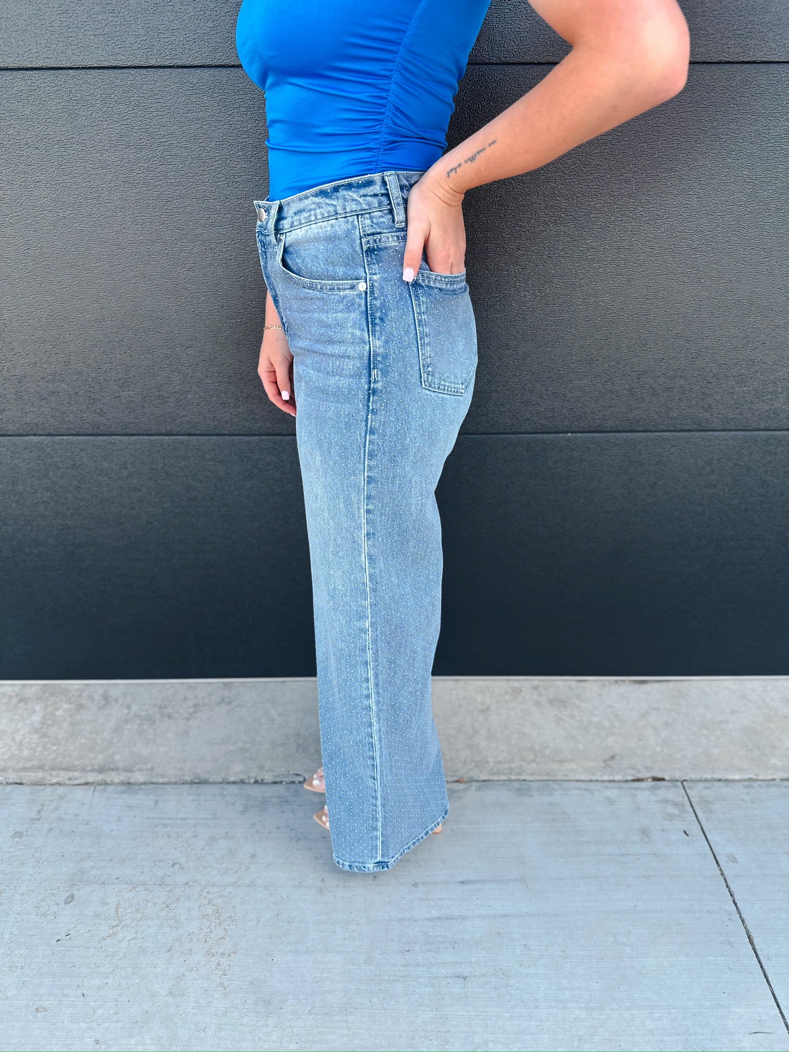 Habitual Gemma slouch wide leg jeans in light blue denim with subtle micro stud detail. Woman's hand in pocket.