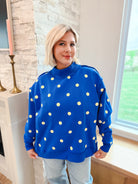 Poppy & Pine Royal Blue Oversized Sweatshirt with yellow polka dots and mockneck. Model wears light wash jeans.
