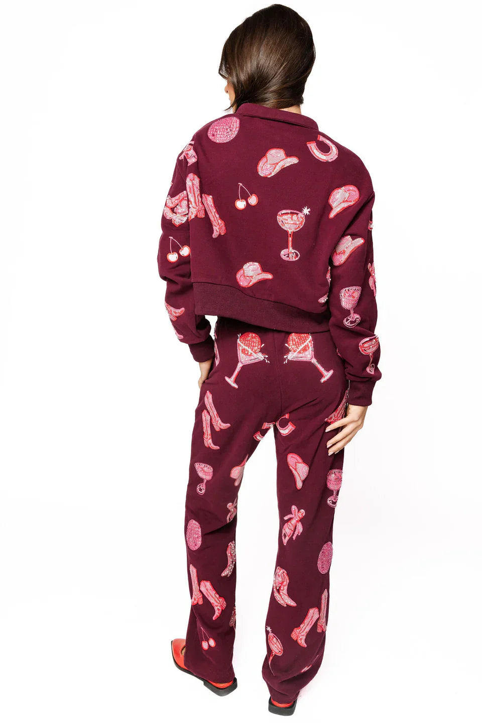 Dark plum sweatshirt and pants set with pink disco cowgirl icons: cowboy hats, boots, cherries, and martini glasses.