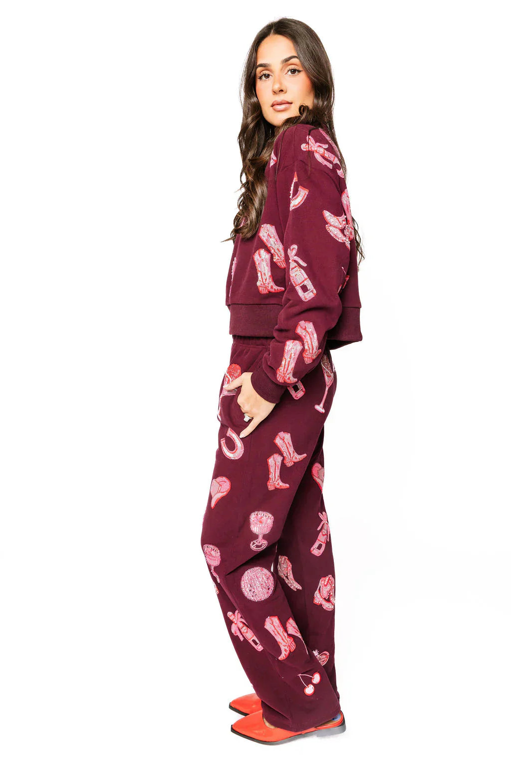 Dark plum henley sweatshirt and pants with all-over pink disco cowgirl icons like boots, cherries, and wine glasses.