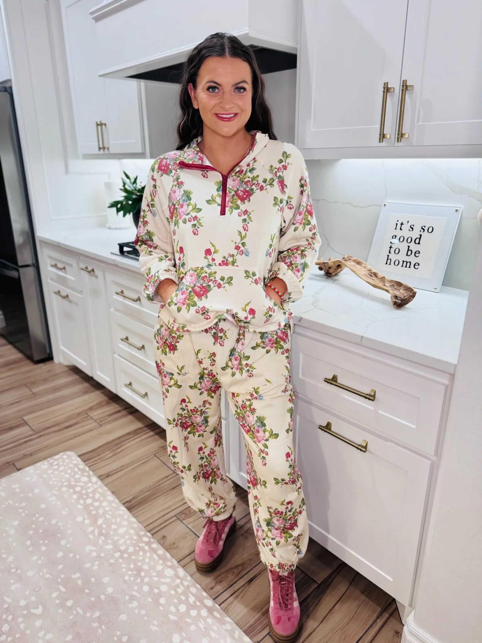 Cream floral half-zip set with pink flowers and green leaves, detailed joggers and long-sleeve top with pocket.