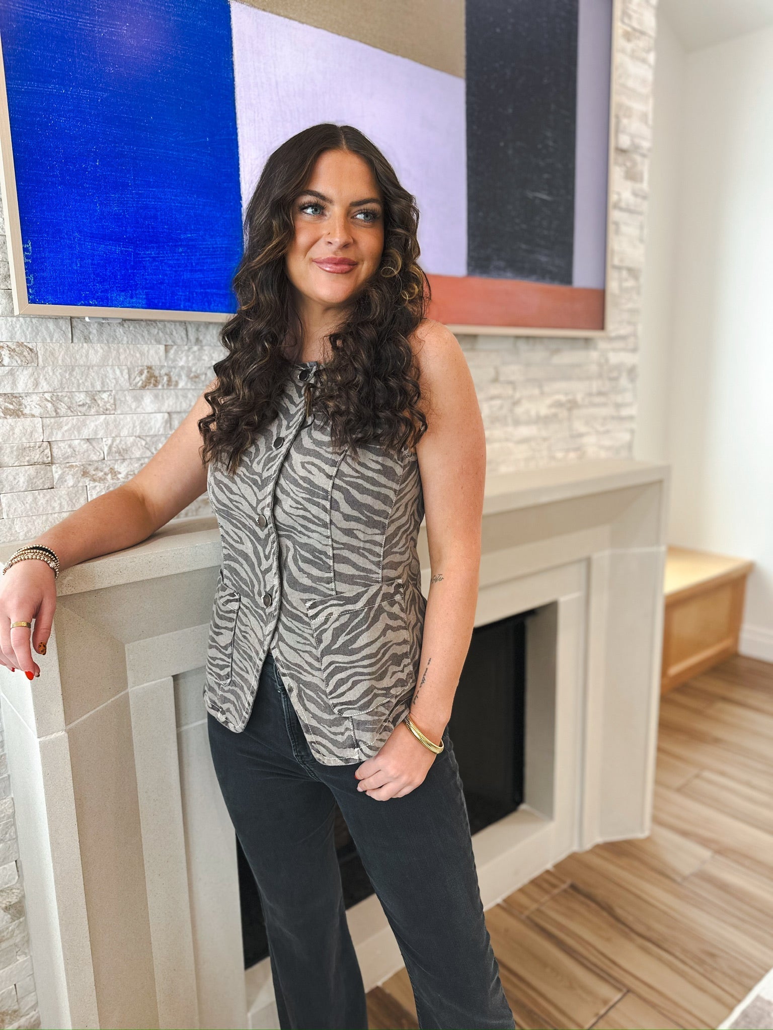 Sleeveless denim vest with a grey and black tiger print, featuring a button-down front and two chest pockets.