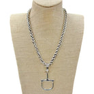 Silver horse bit necklace with a thick, braided chain and a detailed D-ring bit pendant.