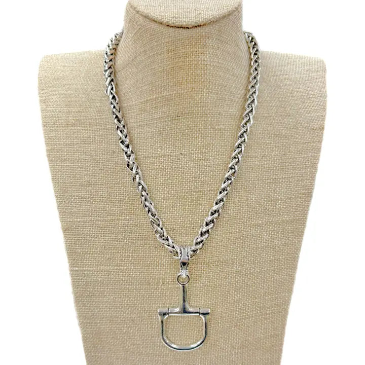 Silver horse bit necklace with a thick, braided chain and a detailed D-ring bit pendant.