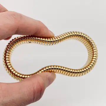 Close-up of the Elastic Gold Plated Bangle - 10 mm, highlighting the durable stainless steel construction and gold plating.