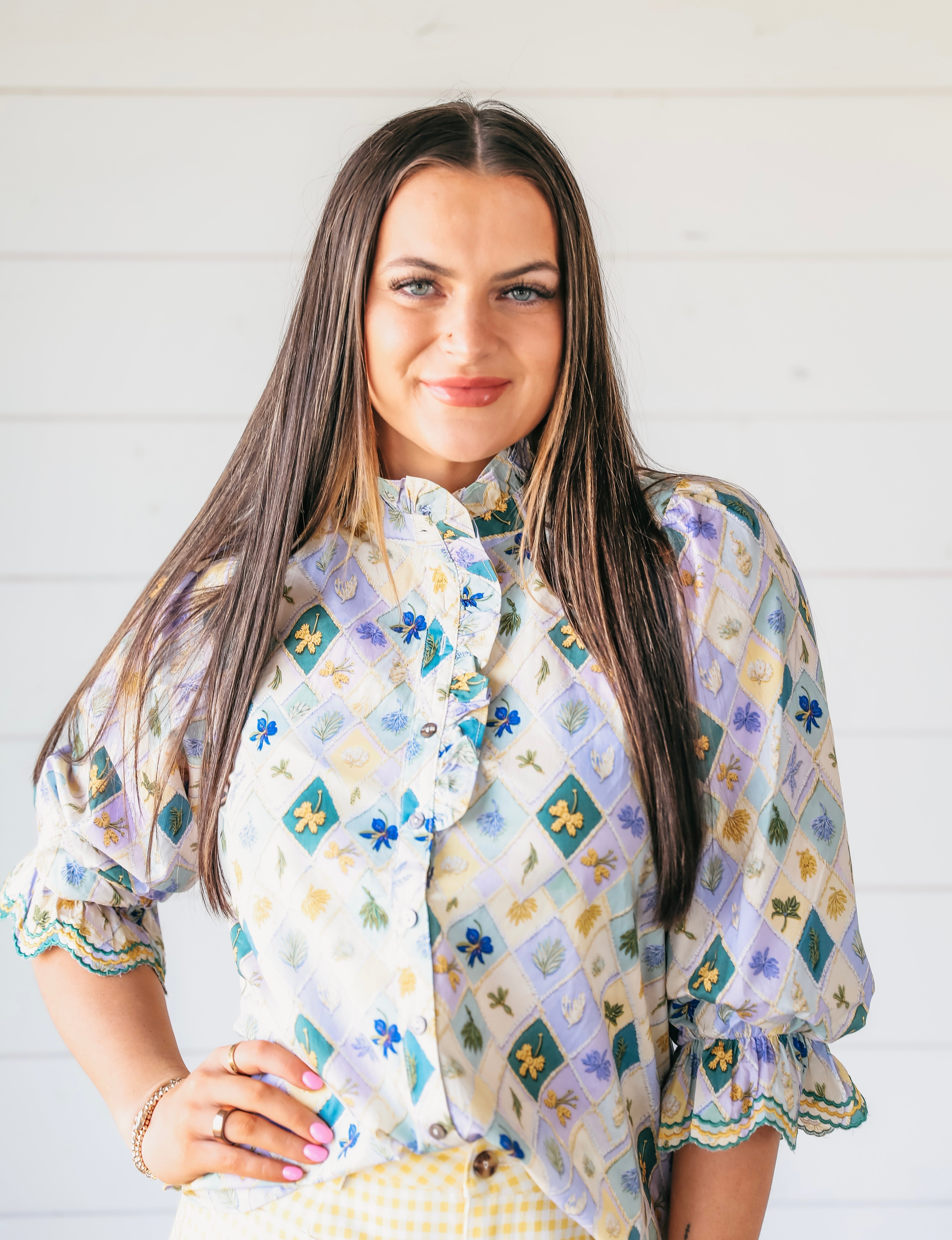 Entro light purple high neck blouse with embroidered floral diamond pattern and ruffle sleeves.