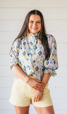 Entro light purple embroidered blouse with ruffled high neck and sleeves, featuring a diamond pattern with floral and