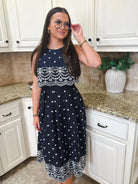 Entro navy blue sleeveless midi dress with white eyelet and floral embroidery. Pleated skirt.