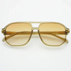 Freyrs Billie unisex aviator sunglasses with amber gradient lenses and translucent beige frames, on a white background.