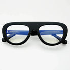 Freyrs Jetsetter black aviator blue light filtering reading glasses with blue temples and clear lenses, white background.