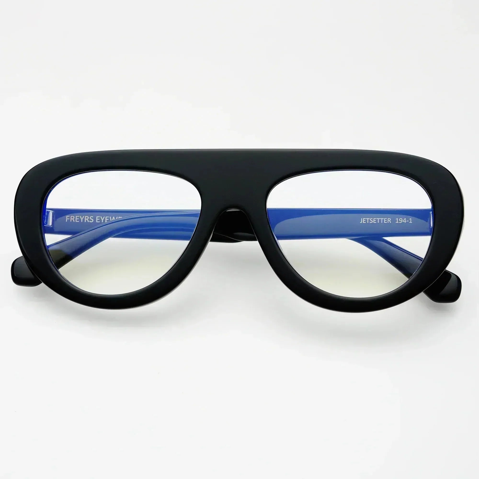 Freyrs Jetsetter black aviator blue light filtering reading glasses with blue temples and clear lenses, white background.