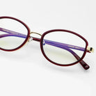 Freyrs Jordan modern oval blue light glasses with burgundy rims, gold accents, and purple temples. Model number JORDAN 209-3.