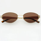 Freyrs Soho small oval sunglasses with gold frame and brown lenses. Tortoiseshell temple tips.