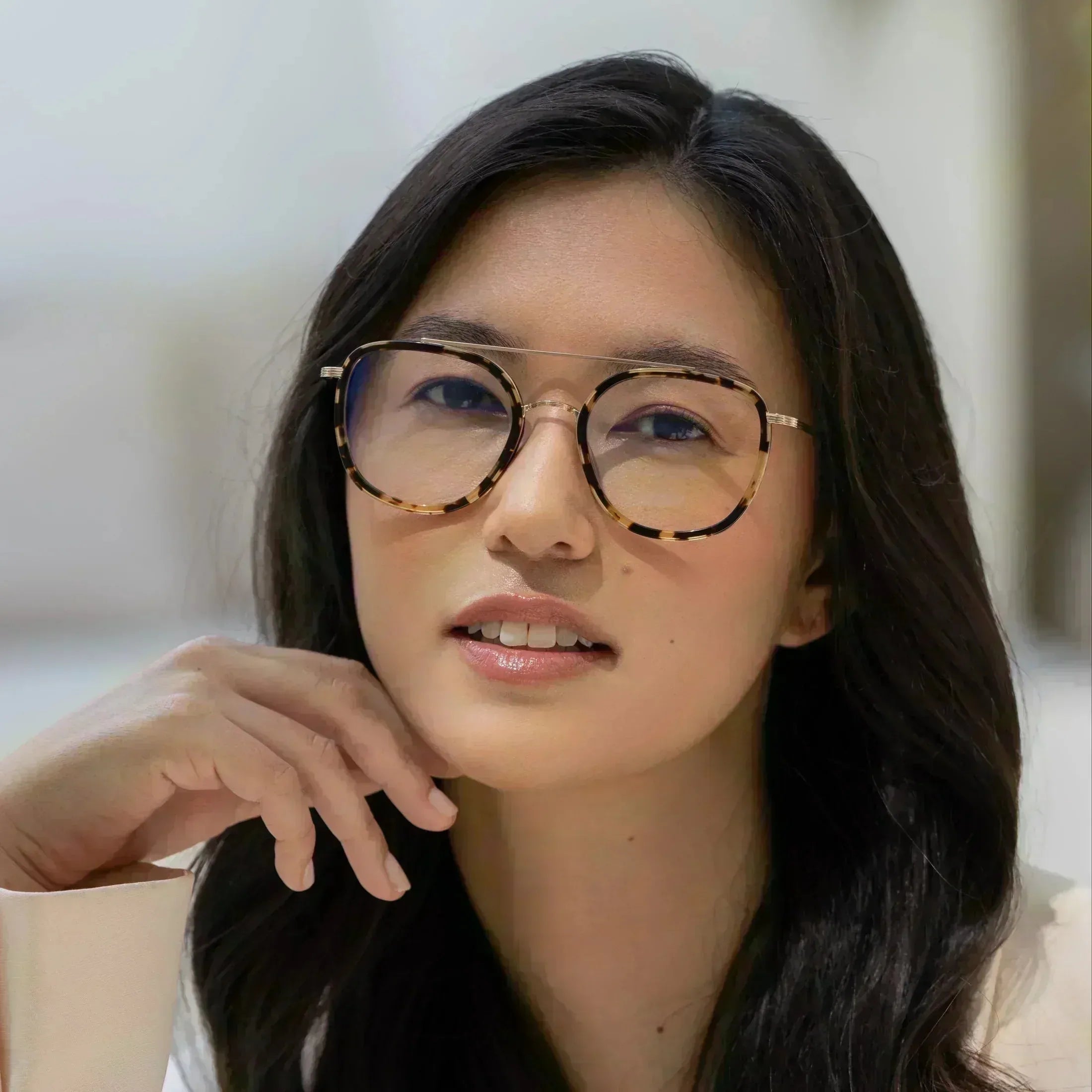 Freyrs Weston unisex round eyeglasses with tortoise shell frames and gold bridge on a woman.