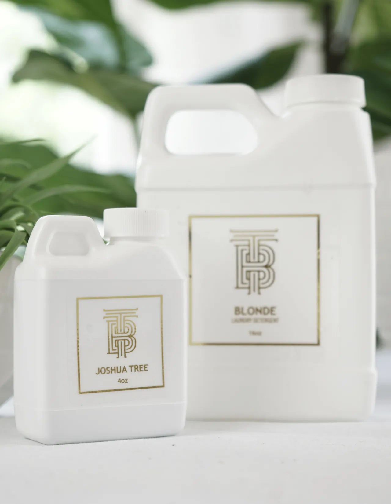 Two white bottles of Thomas Blonde laundry detergent. One is 4oz "Joshua Tree" scent, the other is larger with "Blonde"