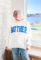 Woman wearing a heather grey mock neck sweatshirt with