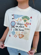 Cream graphic tee with baseball theme: 'Play Ball', baseball field, bats, gloves, hot dog, popcorn, MVP award, foam finger