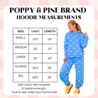 Poppy and Pine blue sweatsuit with white polka dots. Model wearing size Medium. Size chart shown with chest and length