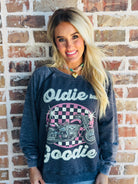 Model wearing the 'OLDIE BUT GOODIE' sweatshirt by Recycled Karma, styled in a casual, chic outfit.