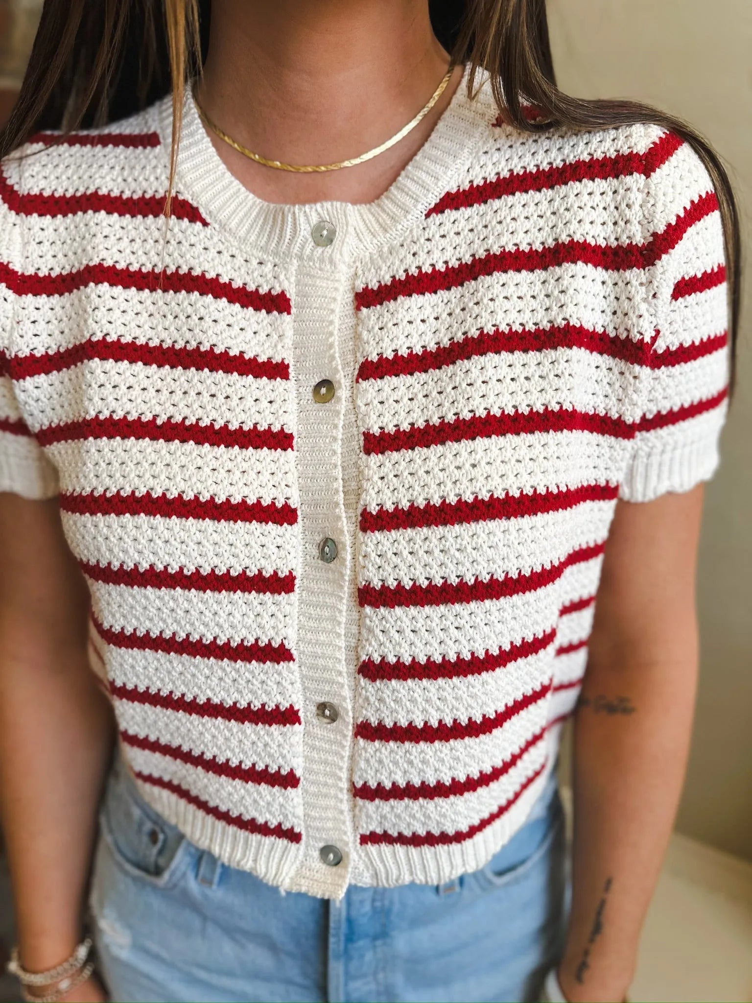 Short sleeve cream and red striped button-down knit cardigan sweater with a crochet-like texture.