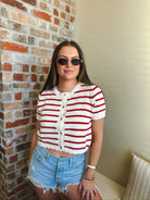 Cropped red and cream striped crochet button-down cardigan sweater with short sleeves.