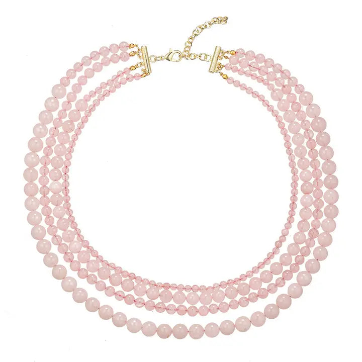 Multi-strand pink rose quartz beaded necklace with gold clasp. Graduated bead sizes.