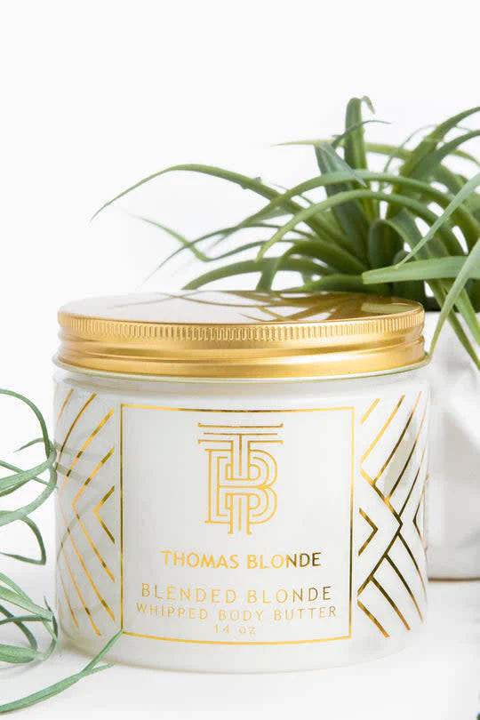 Thomas Blonde Blended Blonde Whipped Body Butter in a 14oz white jar with a gold lid and geometric gold patterns.